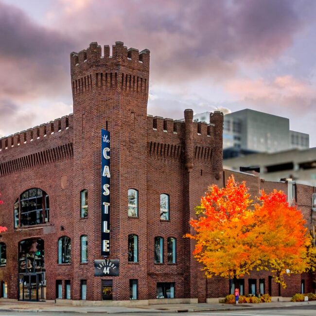 Picture of trees in fall colors in front of the historic venues at the Castle building in Rochester MN